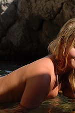 Naked blonde with long hair in the water 04