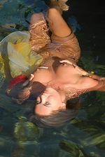 Naked blonde with long hair in the water 14